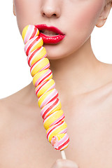 Image showing Close-up shot of woman\'s mouth bright red lips with lollipop. blowjob simulation