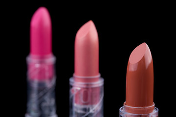 Image showing bright lipsticks on a black background