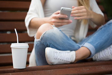 Image showing beautiful girl on the street corresponded by phone. 