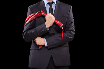 Image showing man in business suit with chained hands. handcuffs for sex games