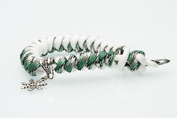 Image showing green braided bracelet on white background. snowflake