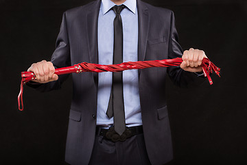 Image showing man in business suit with chained hands. handcuffs for sex games
