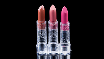 Image showing bright lipsticks on a black background