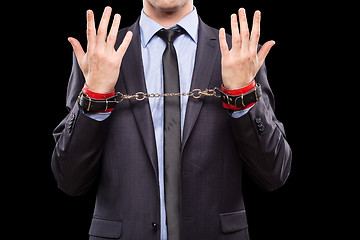 Image showing man in a business suit with leather bound. handcuffs. sex Toys