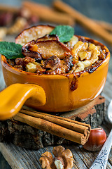 Image showing Bowl of porridge with apple, nuts and cinnamon.