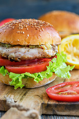 Image showing Tasty burger with chicken, tomato and spicy sauce.