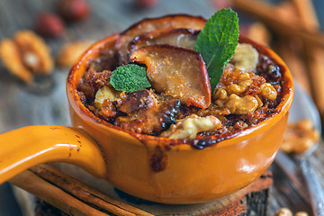 Image showing Delicious baked oatmeal with apples, nuts and spices.