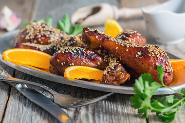 Image showing Chicken drumsticks with sesame seeds.