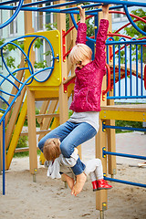 Image showing Mother and daughter playing on the playground outdoors