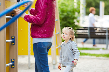 Image showing Mother and daughter playing on the playground outdoors