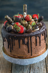 Image showing Cake decorated with strawberries, chocolates and wafer rolls.