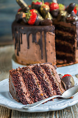 Image showing Piece of delicious chocolate cake with strawberries.