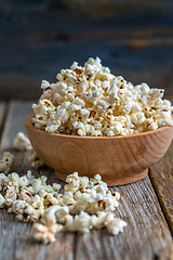 Image showing Tasty popcorn in a wooden cup.