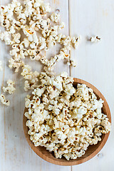 Image showing Popcorn in wooden bowl. View from above.