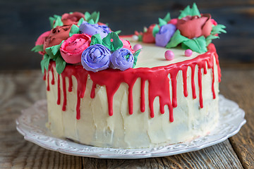 Image showing Cake decorated with flowers from cream and red chocolate.