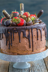Image showing Chocolate cake decorated with fresh strawberries.