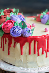 Image showing Cake with red chocolate and flowers.