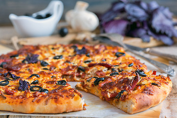 Image showing Appetizing pizza with salami, black olives and cheese close up.