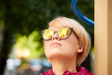 Image showing Young woman with blond hair wearing sunglasses