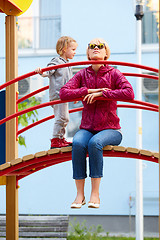 Image showing Mother and daughter playing on the playground outdoors