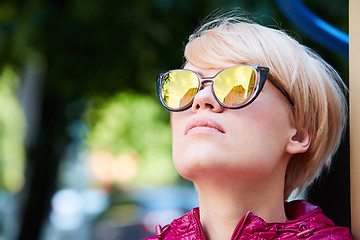 Image showing Young woman with blond hair wearing sunglasses