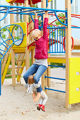 Image showing Mother and daughter playing on the playground outdoors