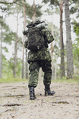 Image showing young soldier with backpack in forest