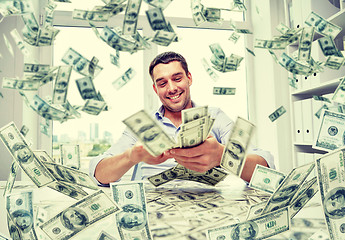 Image showing happy businessman with heap of money