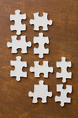 Image showing close up of puzzle pieces on wooden surface