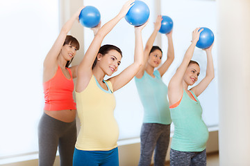 Image showing happy pregnant women exercising with ball in gym