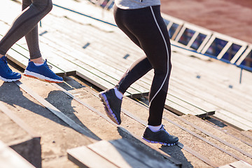 Image showing close up of couple running downstairs on stadium