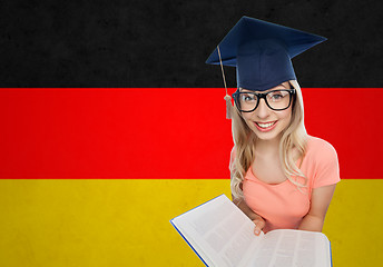 Image showing student woman in mortarboard with encyclopedia