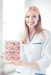 Image showing female doctor with tablet pc and smiles