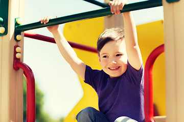 Image showing happy little boy climbing on children playground