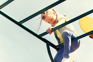 Image showing happy little girl climbing on children playground