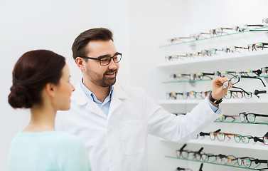 Image showing optician with glasses and woman at optics store