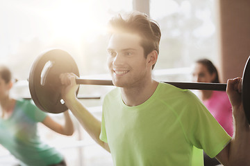 Image showing group of people exercising with barbell in gym