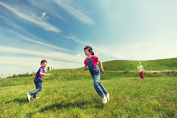 Image showing group of happy kids running outdoors