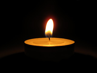 Image showing Bright burning candle in the dark       