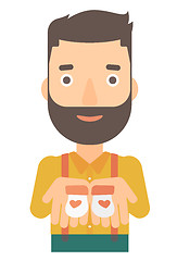 Image showing Man holding baby booties.