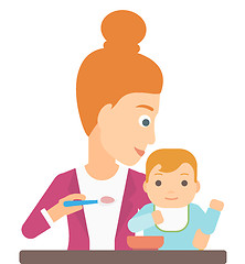 Image showing Woman feeding baby.