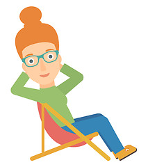 Image showing Woman sitting in a folding chair.