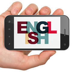 Image showing Learning concept: Hand Holding Smartphone with English on  display