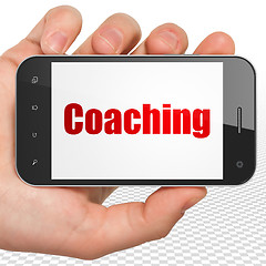 Image showing Learning concept: Hand Holding Smartphone with Coaching on display