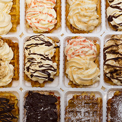 Image showing Assortment of Belgium waffles with cream and toppings.