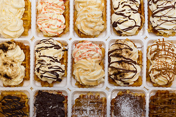 Image showing Assortment of Belgium waffles with cream and toppings.