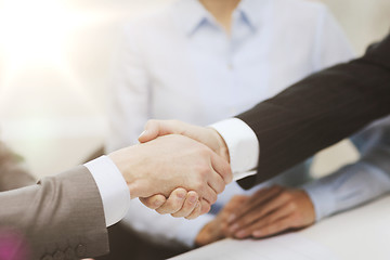 Image showing two businessmen shaking hands in office