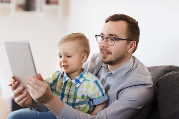 Image showing father and son with tablet pc playing at home