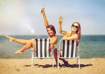 Image showing girls sunbathing on the beach chairs