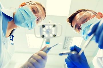 Image showing close up of dentist and assistant at dental clinic